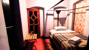 Heritage Single Bedroom with antique furniture and modern amenities at Sett Heritage Residency
