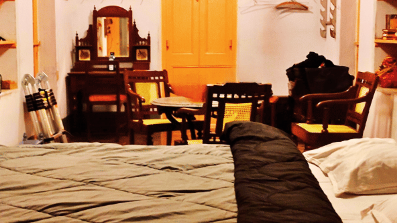 Spacious Heritage Family Suite with vintage furniture and multiple beds at Sett Heritage Residency
